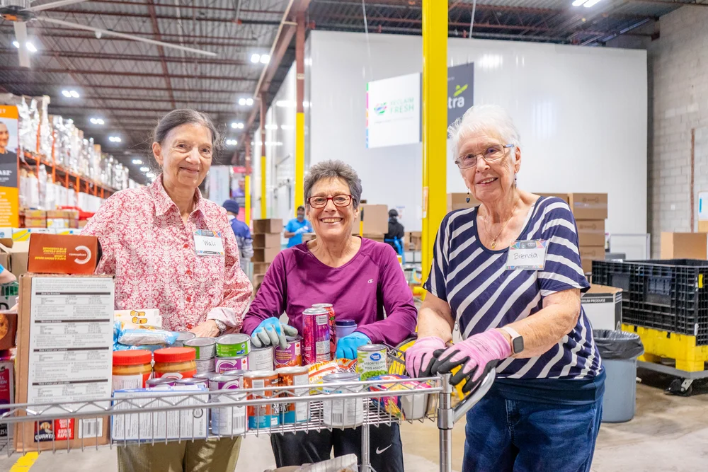 Warehouse volunteers sorting donations