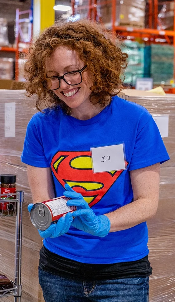 Smiling Volunteer working at Food Banks Mississauga warehouse